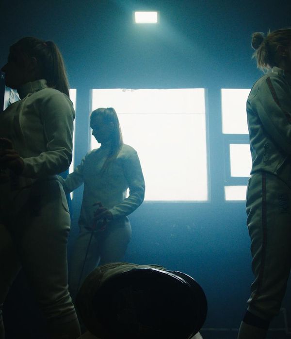 Woman in athletic wear ready for a morning run in a bright, modern space.